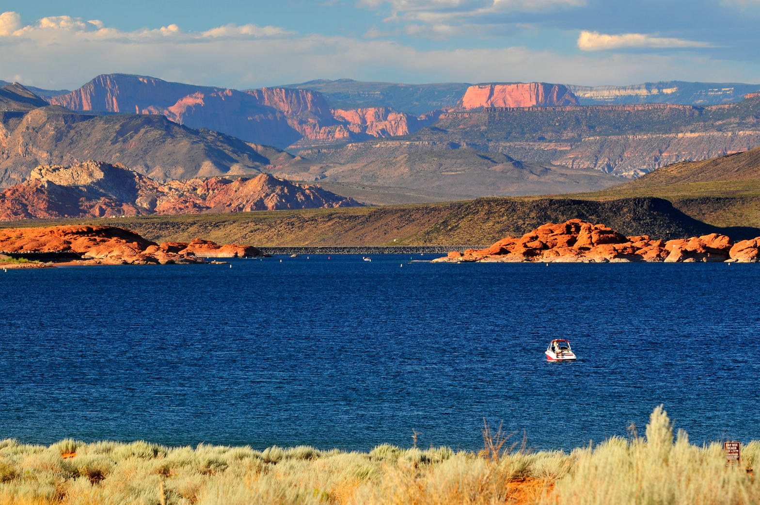 Sand Hollow Reservoir with red rock cliffs behind it